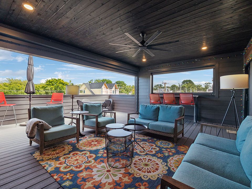 The 3rd floor deck with Trex decking has an expansive covered area with ceiling fan and retractable floor to ceiling outdoor screens.