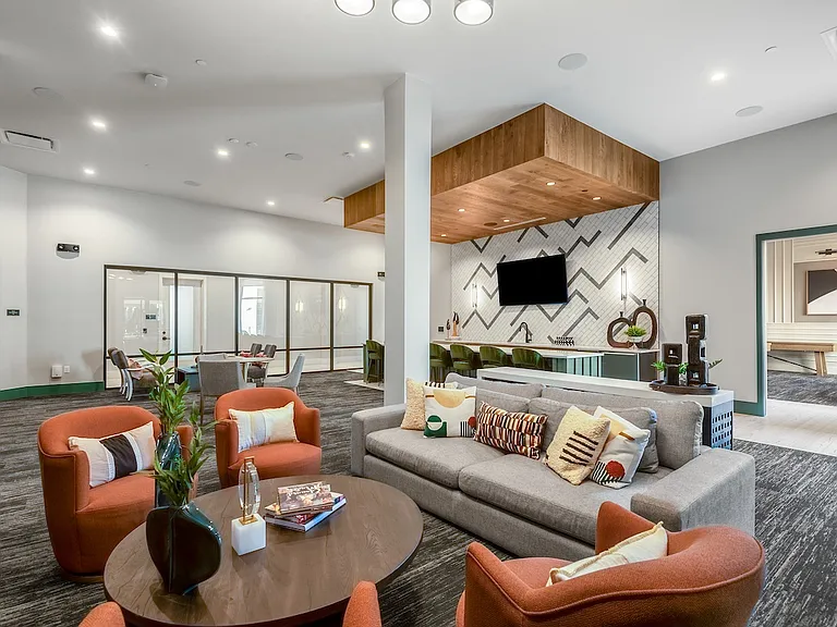 Inviting Resident Lounge with Sectional Sofa and Built-In Bar with TV