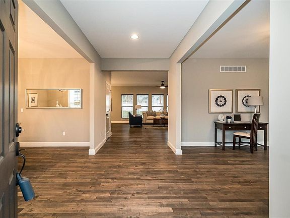 A view of the 20 Feet Main Entry offers quite the reception for your guests and you can feel the urge to spread your wings in this Open Concept Floor Plan.  With the wide opening to the adjoining spaces, a foyer table could easily showcase seasonal flowers or a prized sculpture.