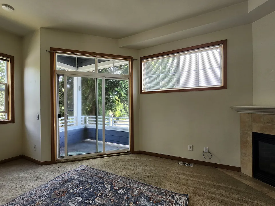 Living room opens out to deck with natural shade