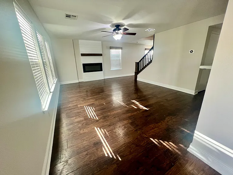Living room with fan and electric fireplace