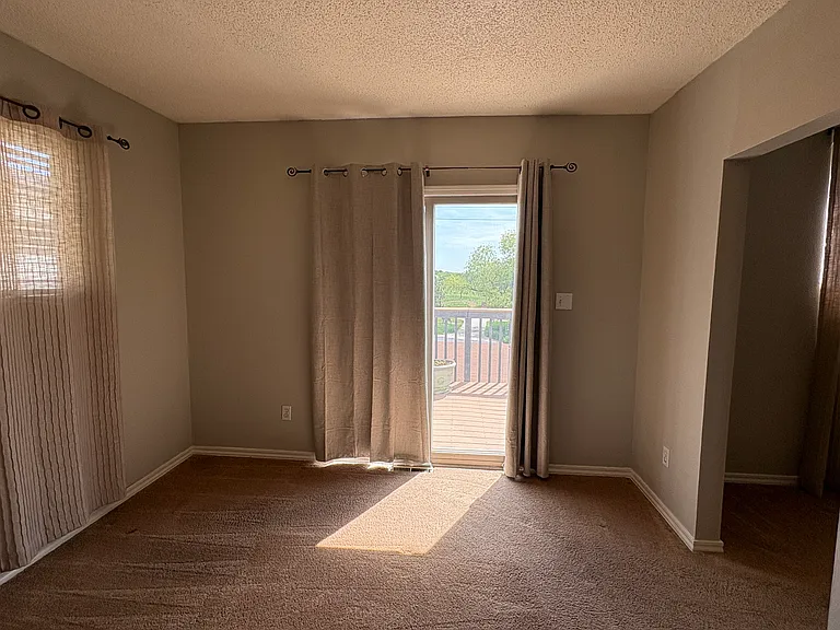 Primary bedroom - sliding glass door to upper deck facing Belmar Park