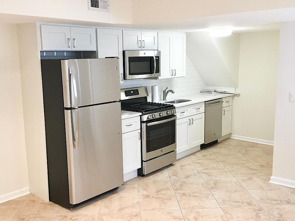 kitchen after renovations - new cabinets - new back splash - new stainless steel appliances - stove - refrigerator, microwave and dishwasher