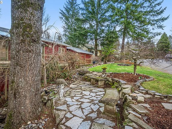 flagstone patio next to waterfall and pond.