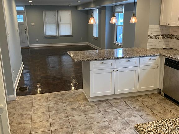 Open floor plan to dining and living room. Hard wood floor and LED recessed lights throughout