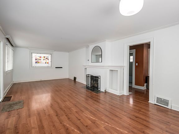 Main entrance. Living/TV area at the North end of the room. Functioning gas fireplace.