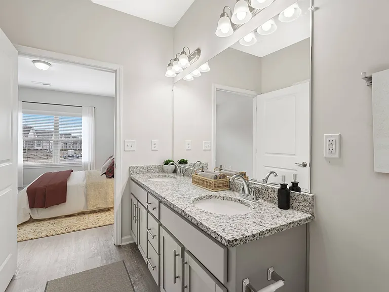 Primary bathroom with double vanity, walk-in shower.