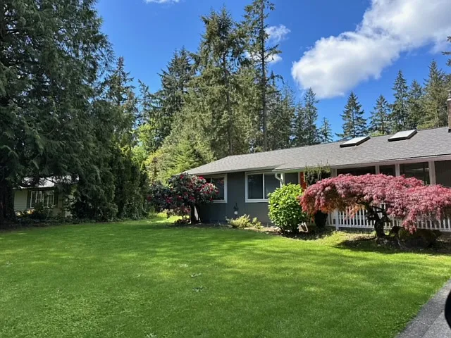 Lush front lawn. Covered front entrance.