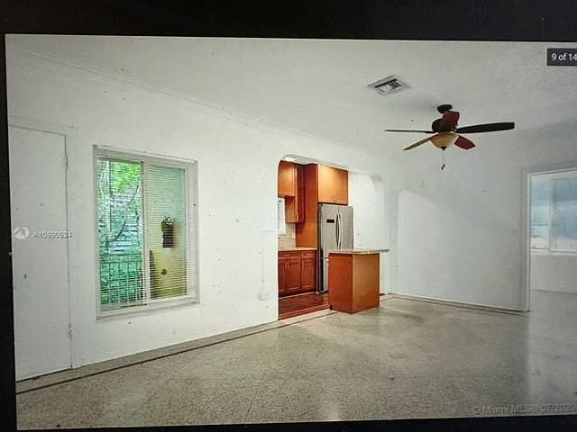 Living room with renovated kitchen - all stainless steel appliances with great island - amazing terrazzo flooring - lots of architectural details - views to very nice landscaped area