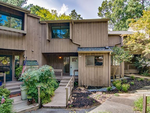 Entrance to Townhome (white door). Two designated parking spaces (tandem-style) right in front of unit. Extra daily parking at Clubhouse or down the street.