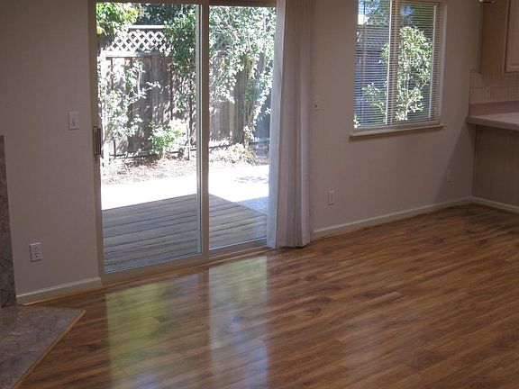 Great room area with fireplace and 6 foot slider onto backyard deck open to the kitchen.