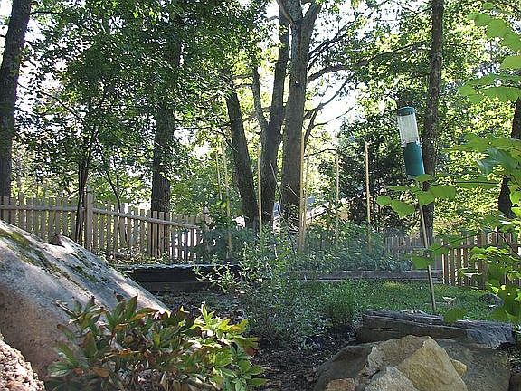 Perrennials, rock walls, garden in back