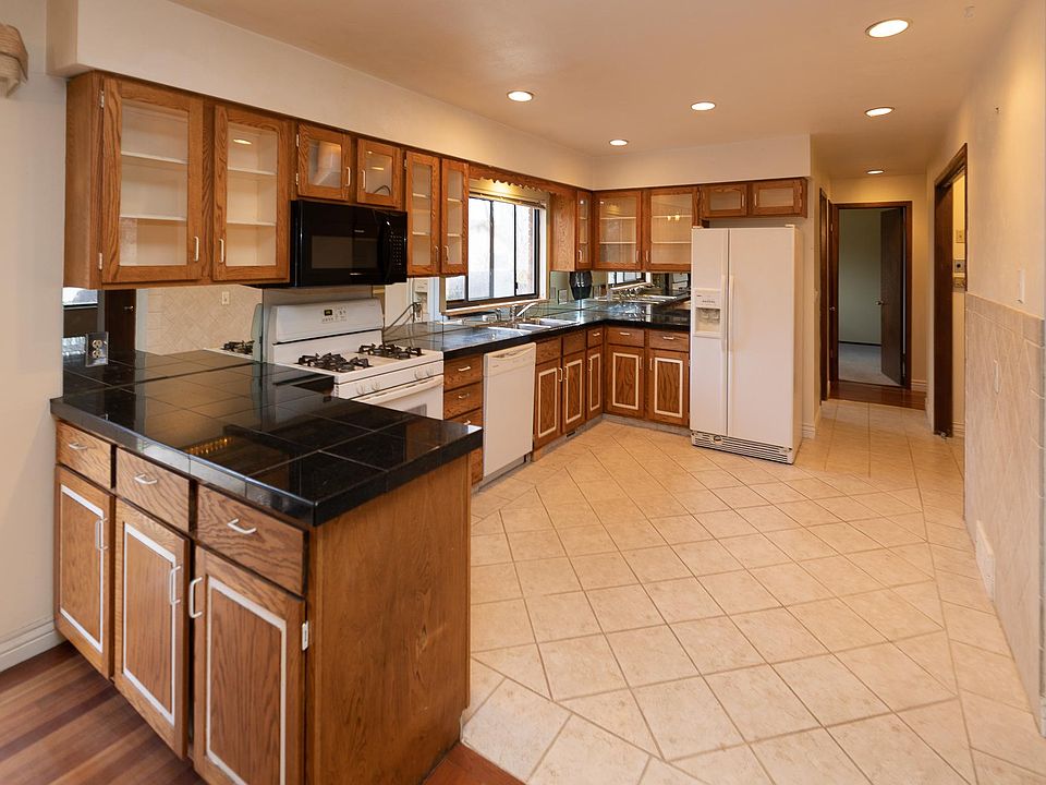 The kitchen! Heart and soul of this house with lit cabinets and an open plan to accommodate a table or soirees!