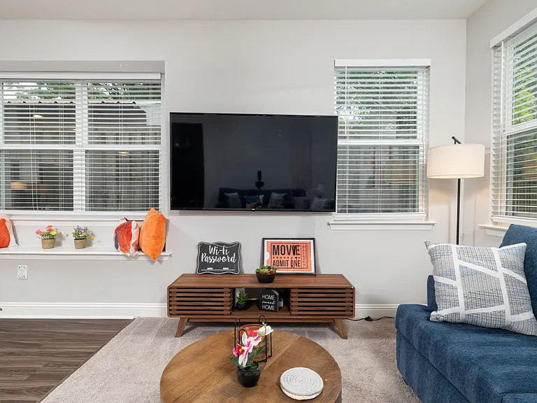Spacious open living room with two comfy couches and a large flat-screen TV_perfect for relaxing nights in or movie marathons.