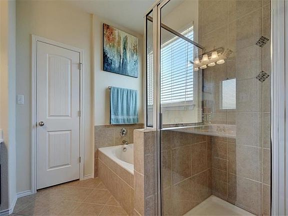 Separate garden tub and shower with rain head faucet. Large walk in closet.