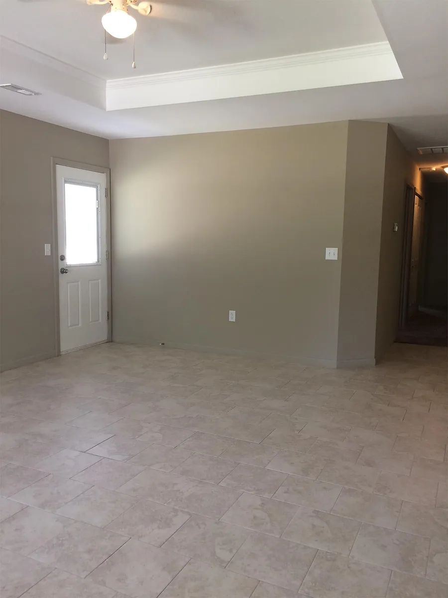 Large open living room with ceiling fan & side patio door - 903 W Market St #A
