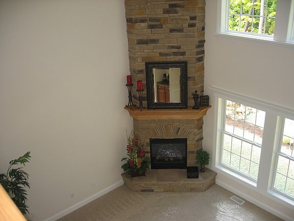 2 Story Great Room with Stone frpl. w/raised hearth, wall of win., carpeting