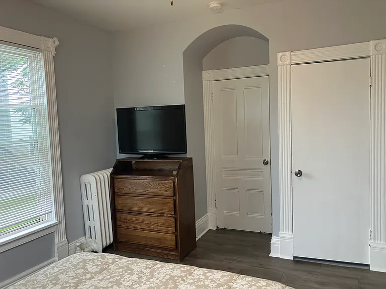 Bedroom 1 with dresser and TV