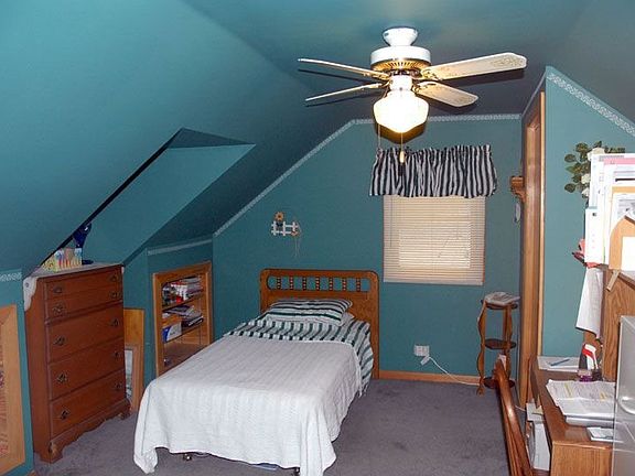 Bedroom w/ built in bookshelves