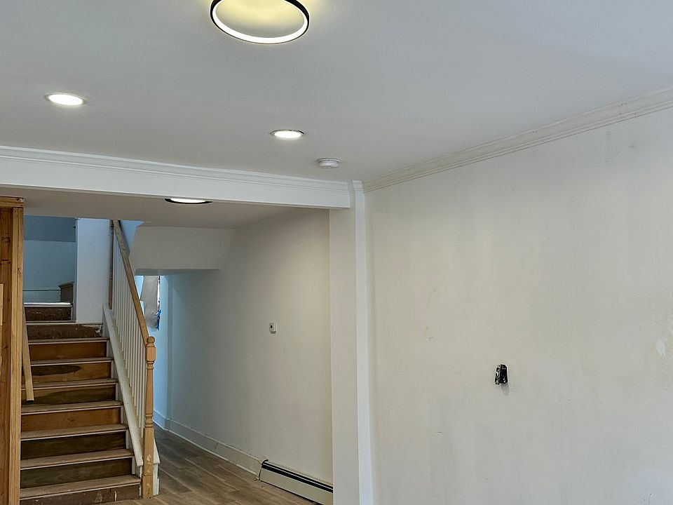 Living Room first floor access to newly built wood staircase to 2nd floor.