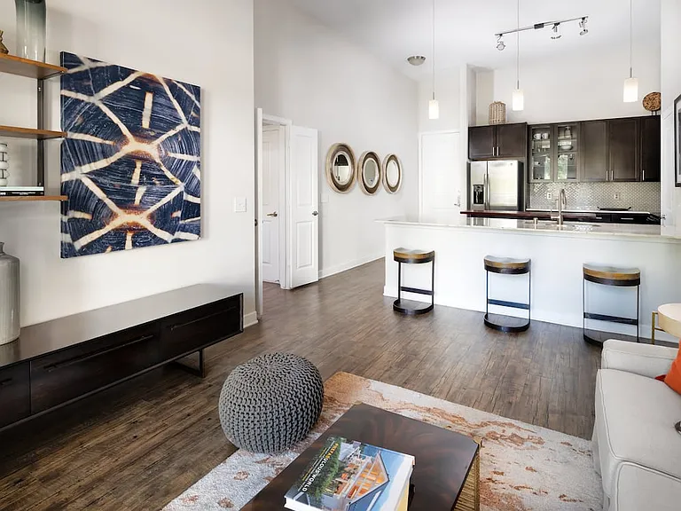 Kitchen, living, and dining areas with hard-surface vinyl plank flooring throughout