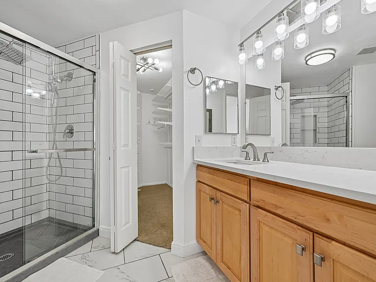 Newly remodeled bathroom with dual rainfall and detachable shower head.
