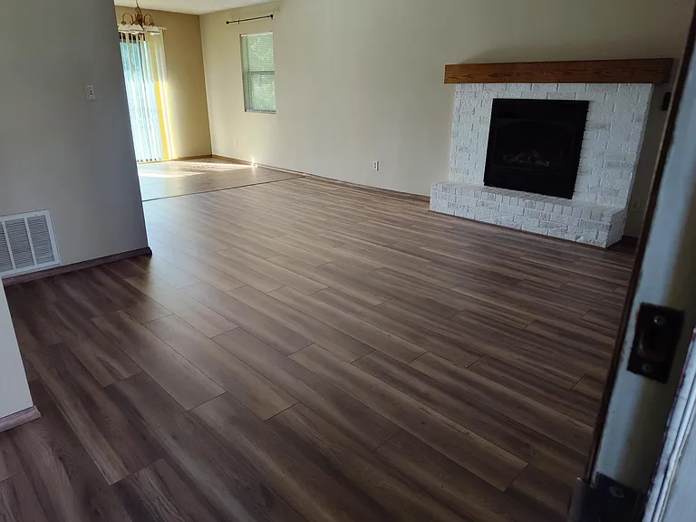 New flooring, fireplace paint, mantle. View from front door.