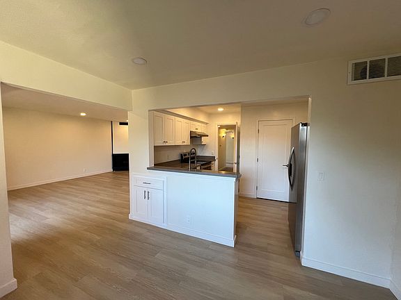 Dining room looking into kitchen, living room