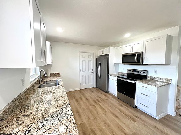 Kitchen looking toward garage door. All stainless steel appliances.