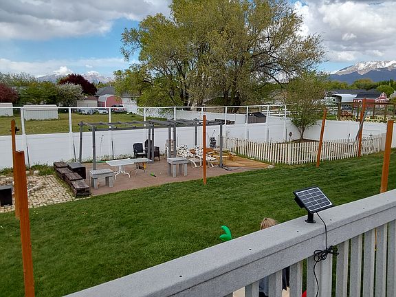 Shared enclosed back yard with patio deck and garden