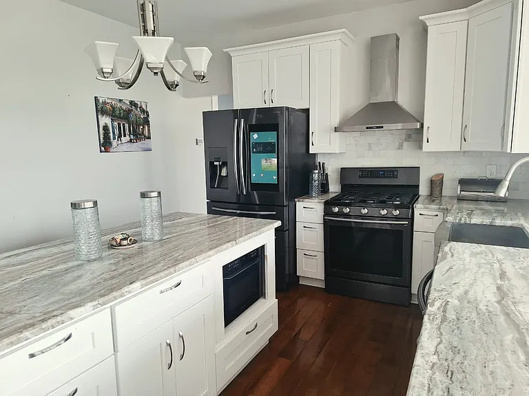 Prepare meals with ease in this fully equipped gourmet kitchen featuring granite countertops, stainless steel appliances, generous prep space, and everything you need to feel at home.
