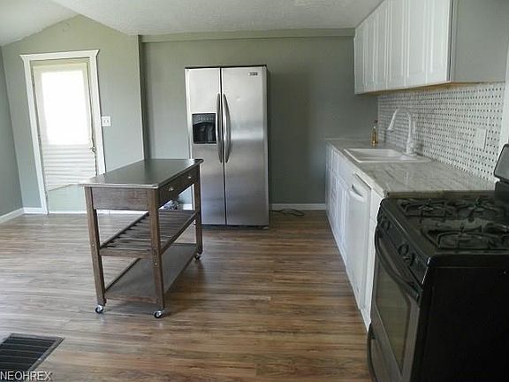 modern kitchen with island appliances stay great marble countertop and laminate flooring