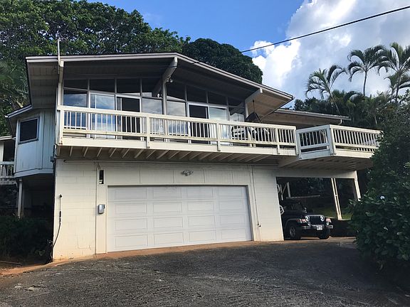 A view from the driveway looking up at the house