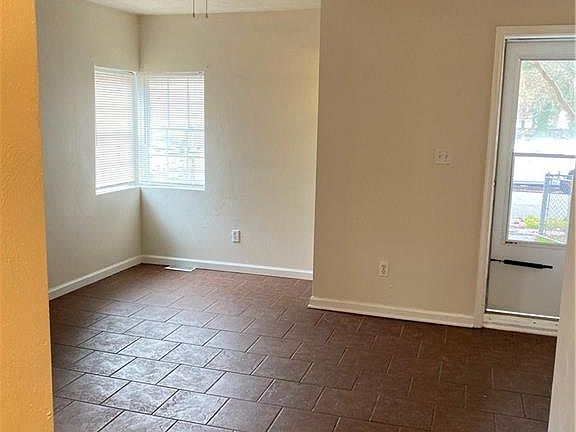 Family room with bright light and tiled flooring.  View of the front door.