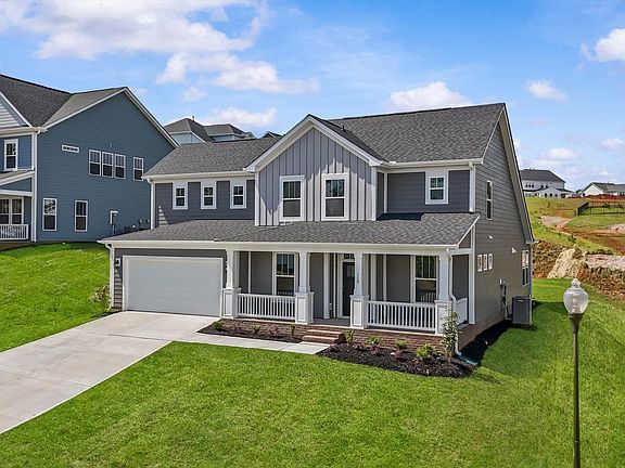 Gray exterior two story home with two car garage at The Grange by DRB Homes in Clemson, SC