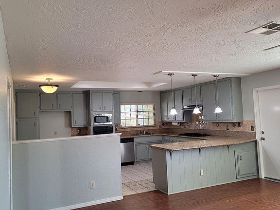 Kitchen looking from family room. Eating area in the kitchen behind the pony wall.