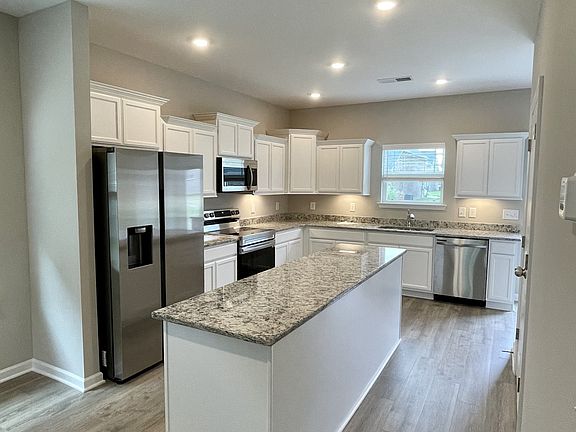 Your kitchen features Samsung Stainless Steel Appliances, granite countertops, as well as a long wo