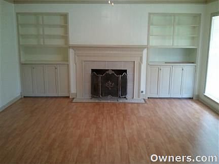 Living room with gas fireplace, ceiling fan and new flooring