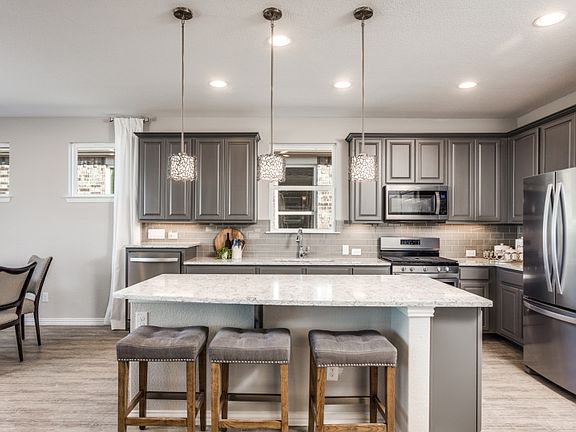 Model Representation - Island kitchen with eat-in bartop and abundant cabinet space