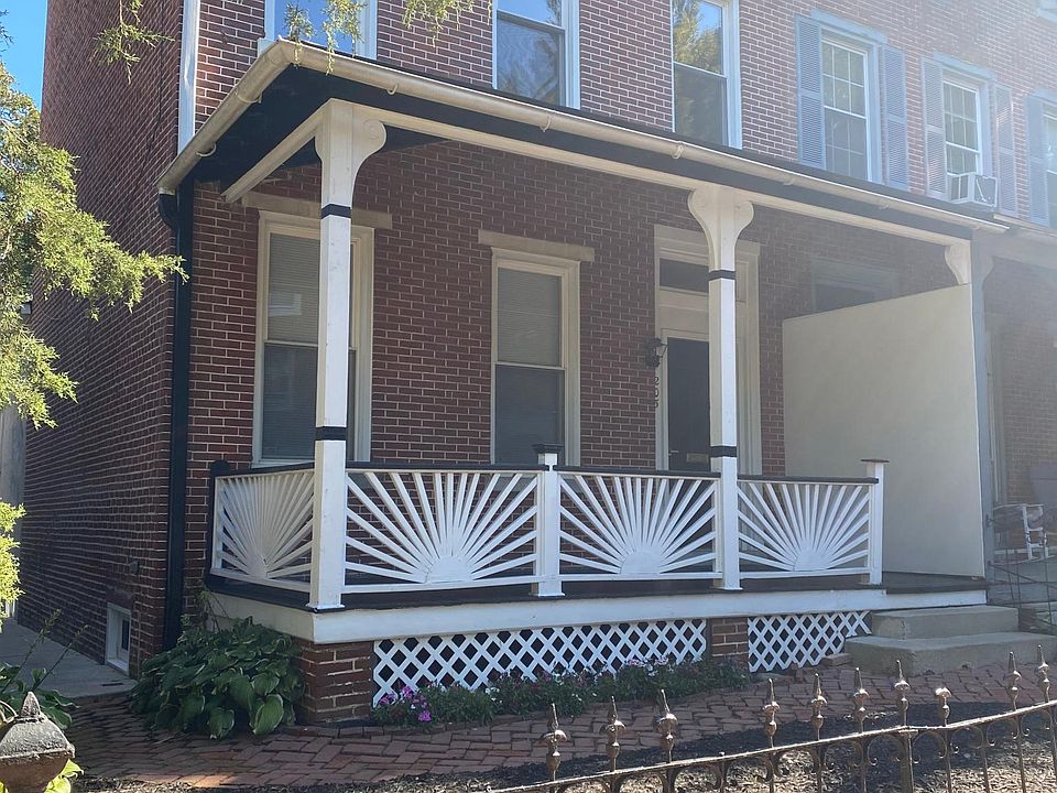 Front yard, newly painted covered front porch, flower beds and new mulch beds.