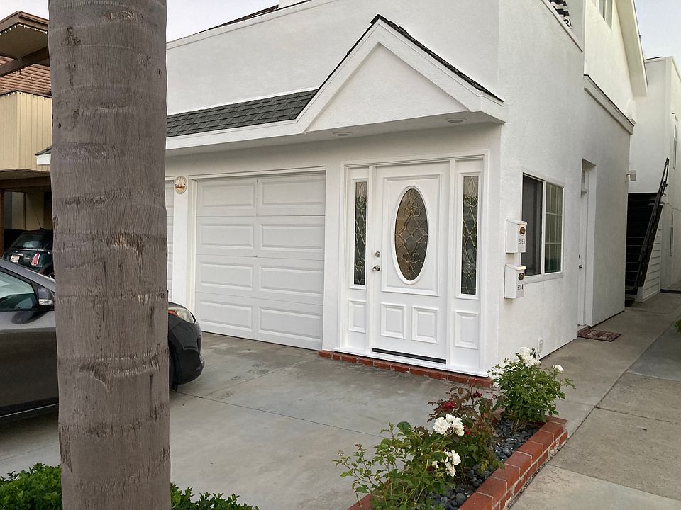 Angled view of duplex. First side door leads to garage.
