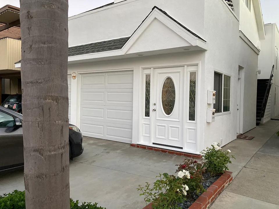 Angled view of duplex. First side door leads to garage.
