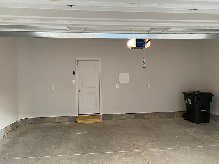 Painted 2 car garage with garage door opener and keypad