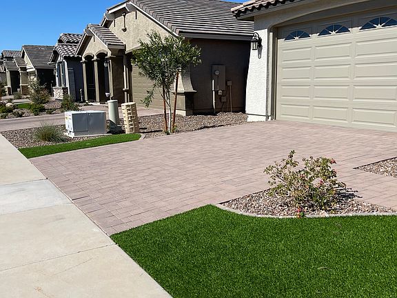 Pavered driveway and walkway with 2 car garage.