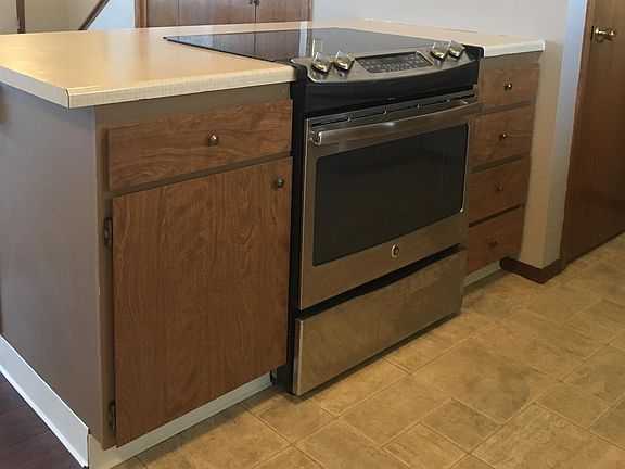 New self-cleaning, smooth surface stove is tucked into an is