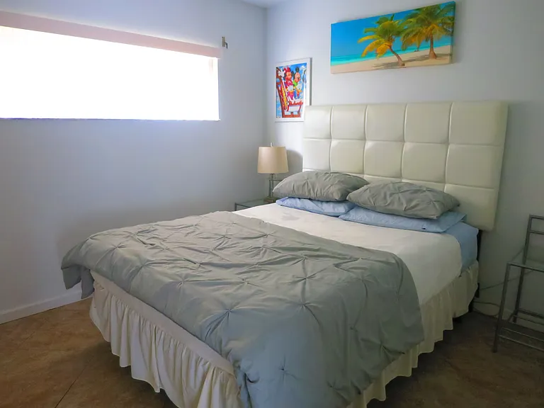 The guest bedroom is equipped with a queen-size bed.