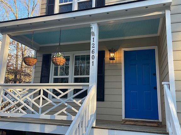 Comfortable front porch with chippendale detail.