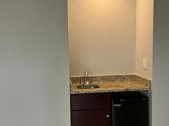 Beverage cooler and sink in family room