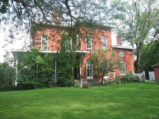 The home is sequestered behind trees that border it....this is what you see when entering the grounds.  A brick path from South Hunter leads you to the side door.  You enter from the porch - what a lovely porch! - into the dining room.
