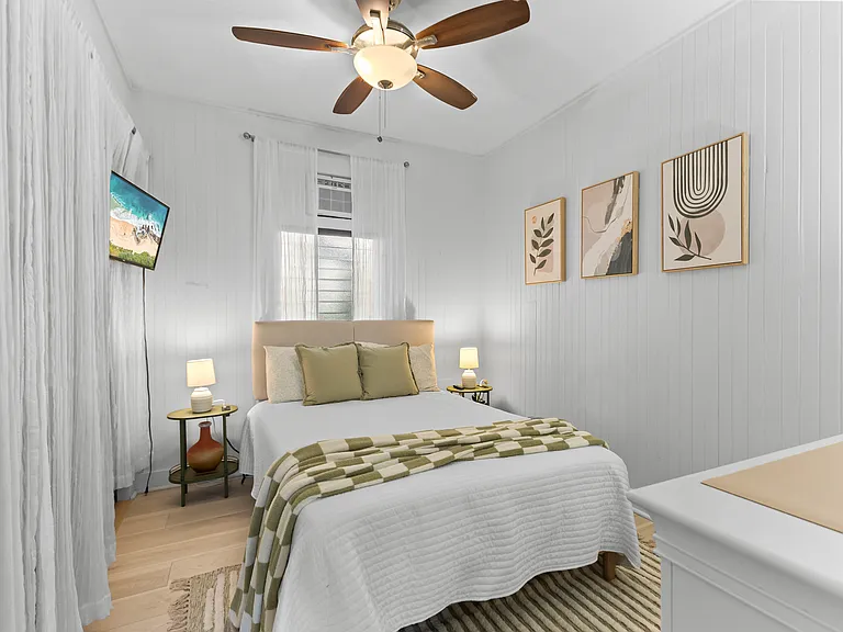 Back bedroom with double bed, AC, ceiling fan, dresser, side tables and large closet with built-in shelving.